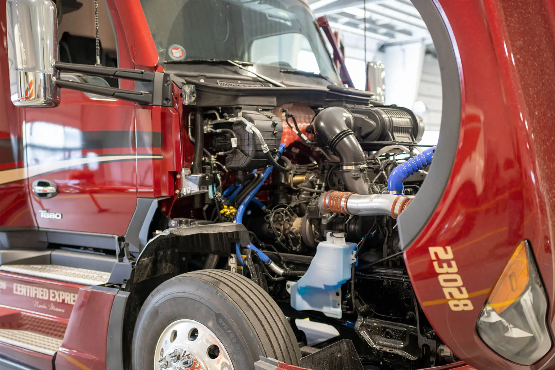 Close up of a truck cab with the engine exposed