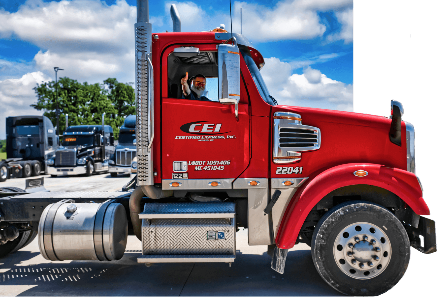 A CEI trucker signals thumbs up out the passenger window of a red truck.