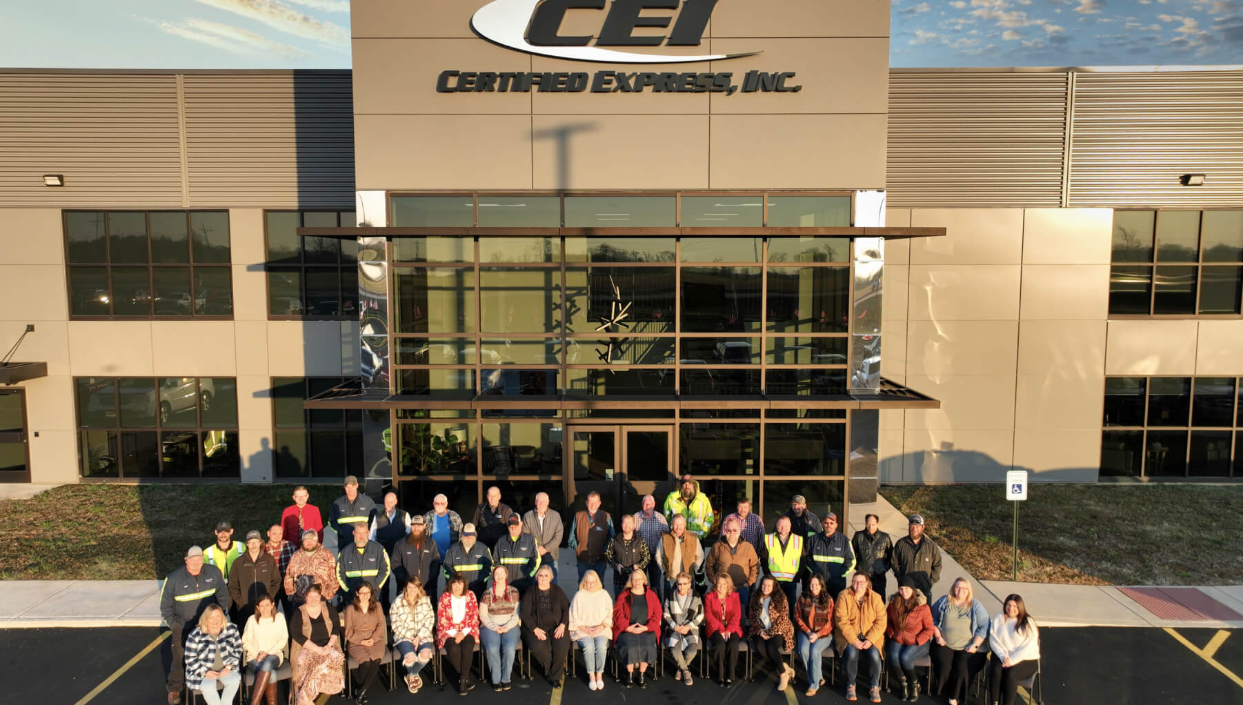 Employees stand in front of Certified Express headquarters for a group photo.