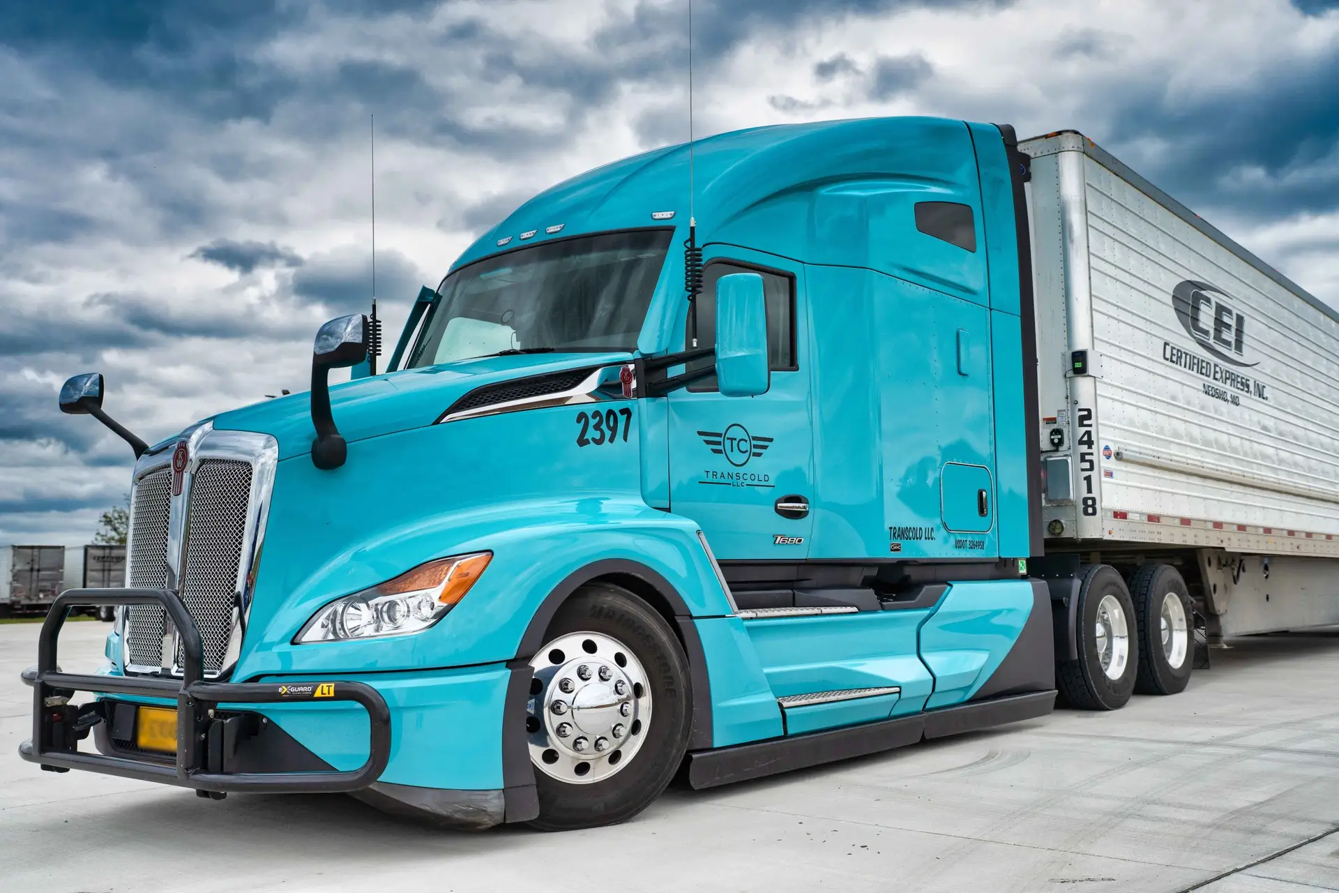 A turquoise semi-truck with the number 2397 is parked, attached to a white trailer with "CEL" and "Certified Express, Inc." written on its side.